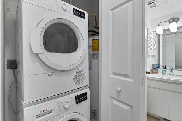 2124 N Tamiami Trl Unit 103, Sarasota, FL 34234 - washroom with stacked washer / drying machine