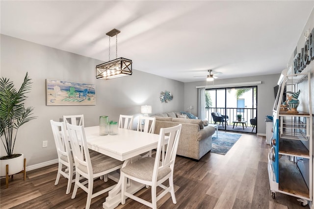 dining area featuring ceiling fan with notable chandelier and dark hardwood / wood-style floors