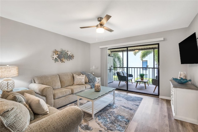 living room featuring hardwood / wood-style flooring and ceiling fan