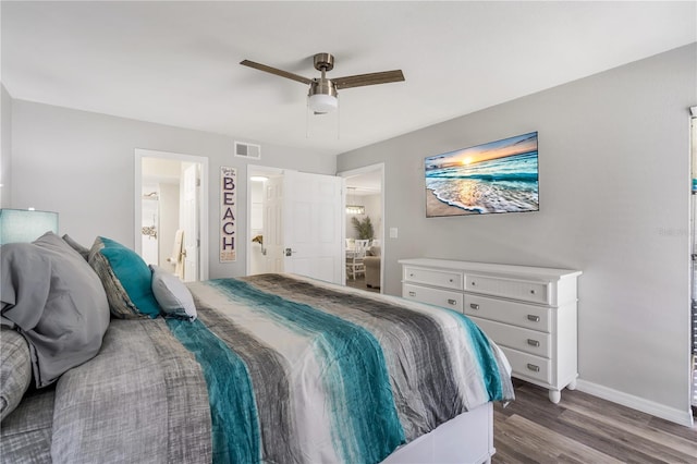 bedroom with hardwood / wood-style flooring, ceiling fan, and ensuite bath