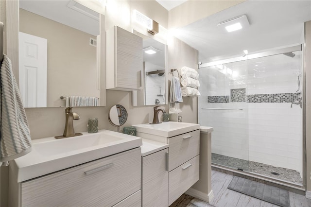 bathroom featuring a shower with door, vanity, and hardwood / wood-style flooring