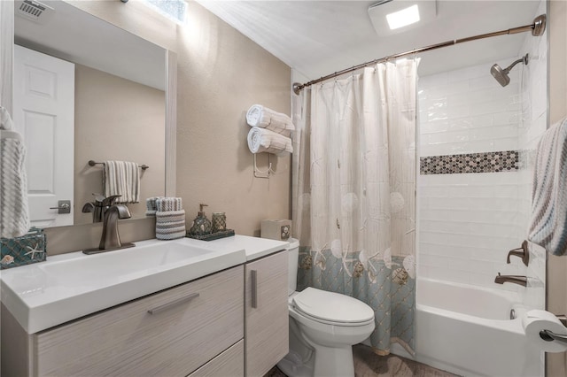 full bathroom with vanity, shower / bath combination with curtain, and toilet