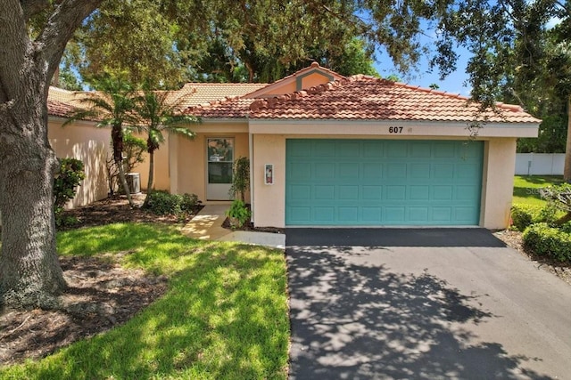 mediterranean / spanish house featuring a garage