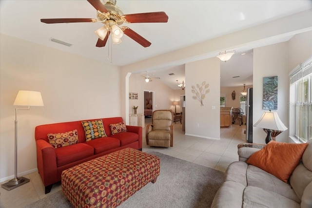 living room featuring ceiling fan, light tile patterned flooring, and lofted ceiling