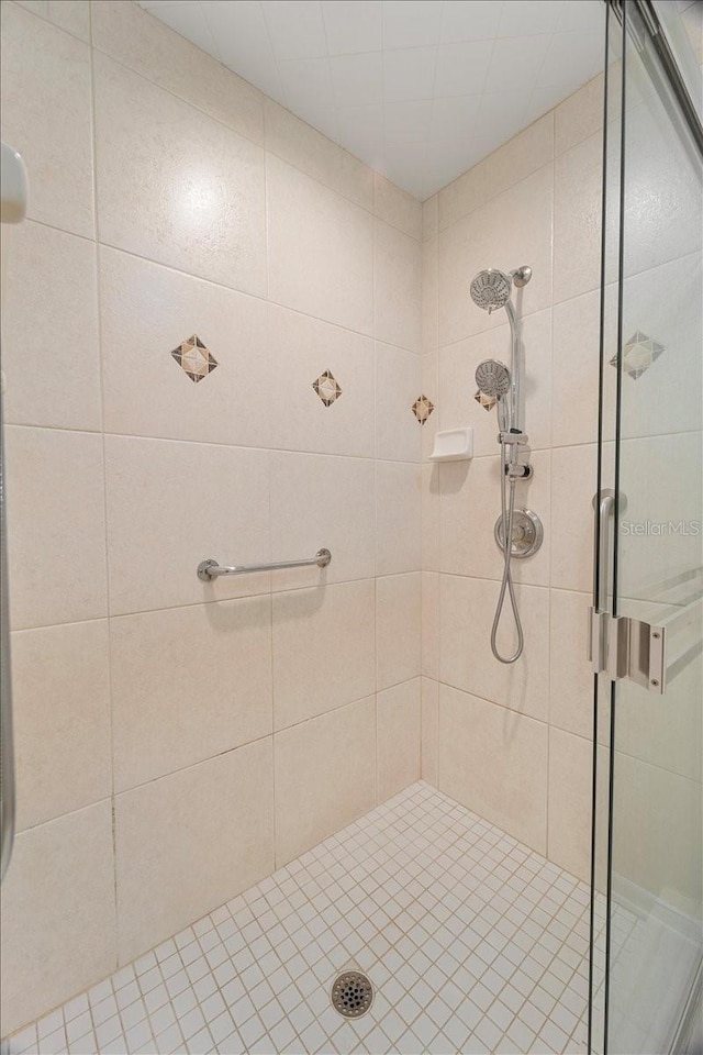 bathroom featuring a shower with shower door