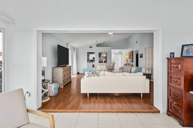 living room featuring light hardwood / wood-style floors and vaulted ceiling