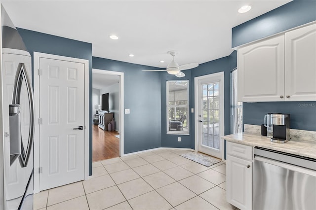 kitchen featuring light tile patterned floors, stainless steel appliances, white cabinetry, and ceiling fan