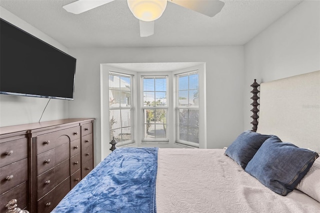 bedroom featuring a textured ceiling and ceiling fan