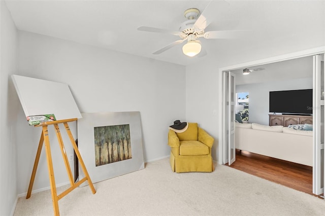 sitting room with carpet floors and ceiling fan