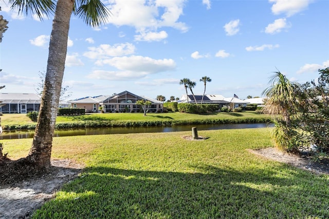 view of community with a lawn and a water view