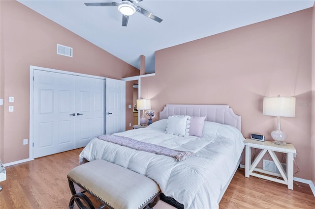 bedroom featuring ceiling fan, a closet, high vaulted ceiling, and light hardwood / wood-style floors