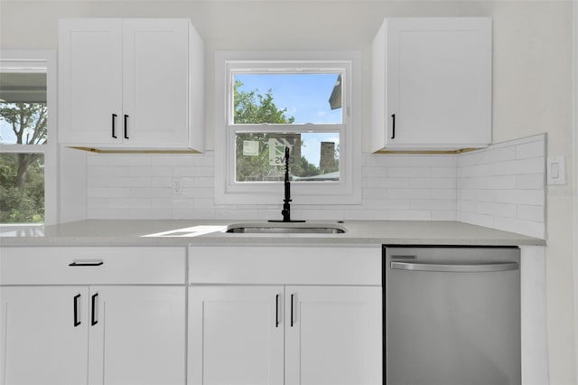 kitchen with dishwasher, tasteful backsplash, white cabinetry, and sink