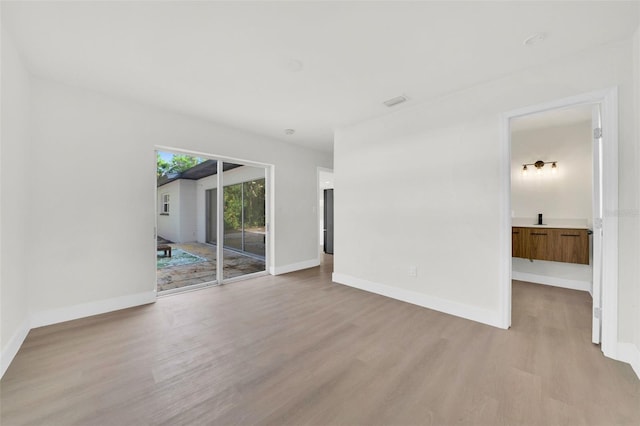 spare room featuring light hardwood / wood-style flooring