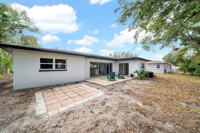 rear view of house with a patio and central AC unit