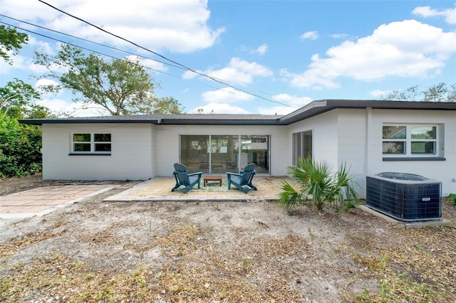 rear view of house featuring a patio area and central AC