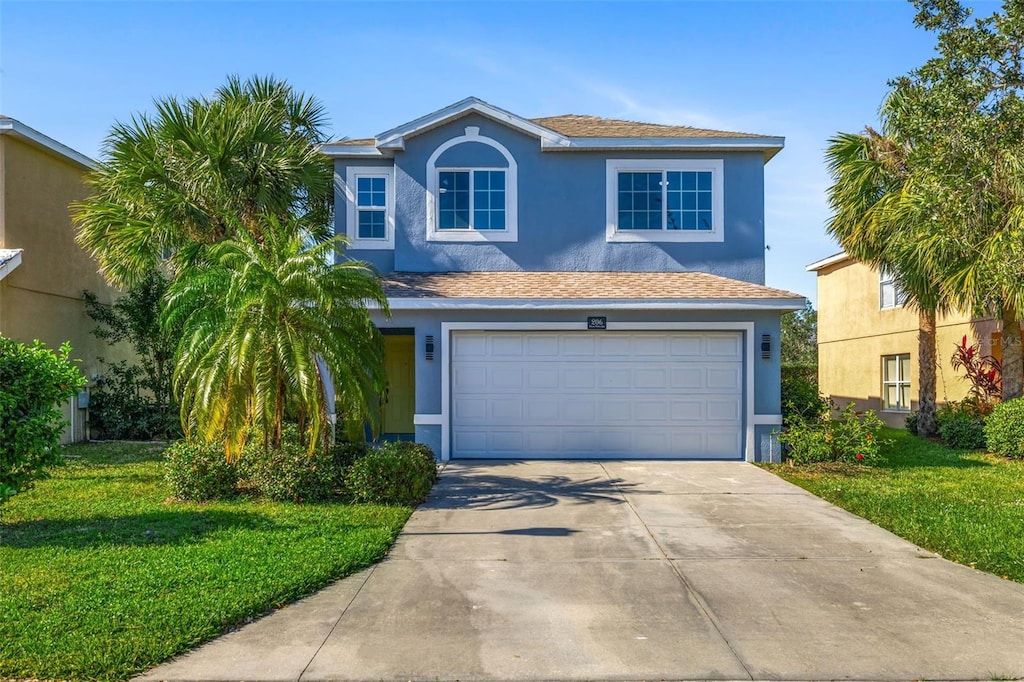 view of front facade featuring a garage and a front yard