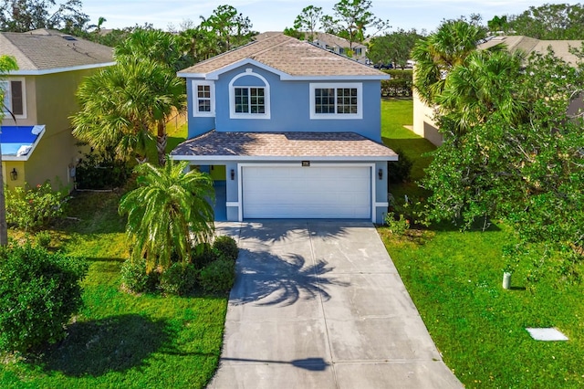 view of front of property featuring a front lawn and a garage