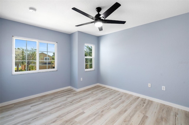 empty room with ceiling fan and light wood-type flooring