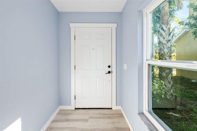 doorway with light wood-type flooring