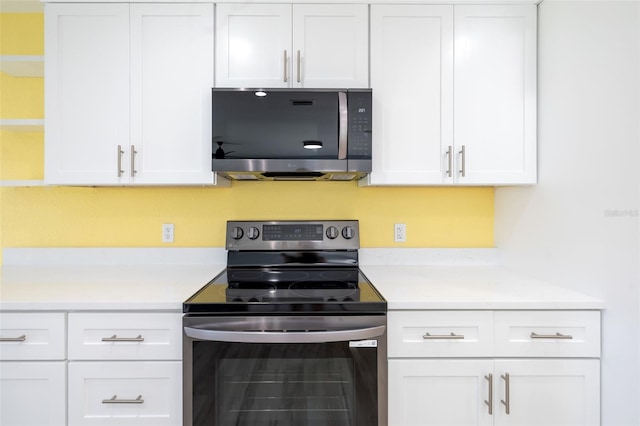 kitchen with white cabinetry and appliances with stainless steel finishes