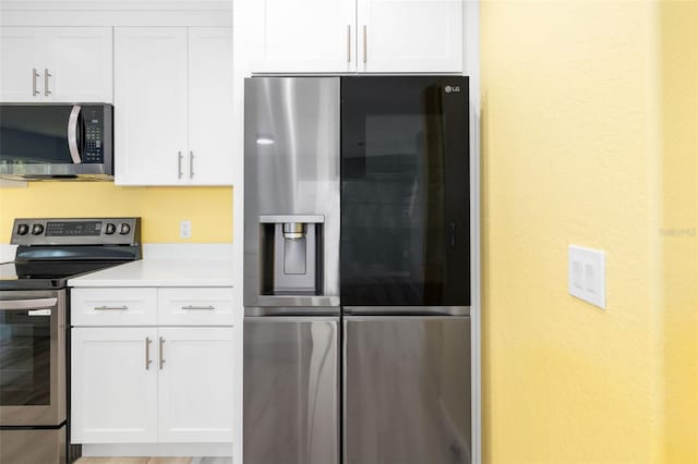 kitchen featuring white cabinetry and appliances with stainless steel finishes