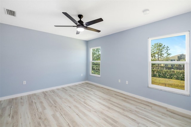 spare room featuring ceiling fan and light hardwood / wood-style floors