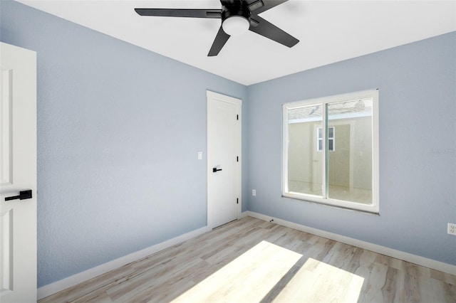 empty room featuring ceiling fan and light hardwood / wood-style flooring