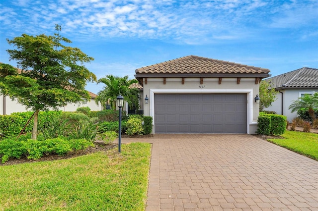 mediterranean / spanish house with a garage