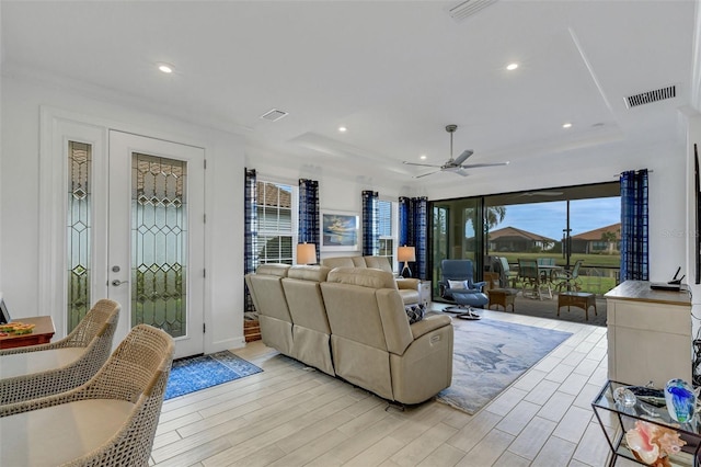 living room featuring light hardwood / wood-style floors and ceiling fan