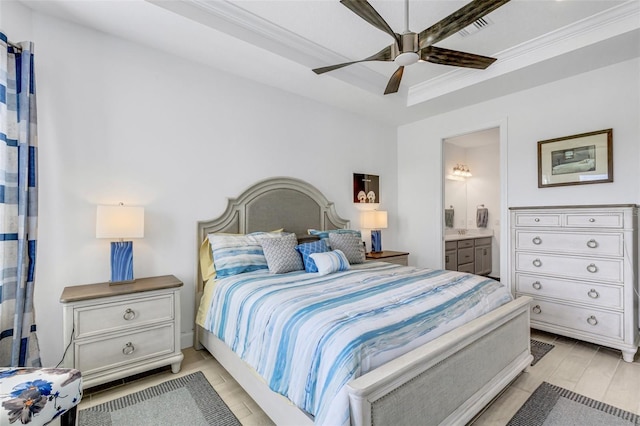 bedroom featuring ceiling fan, light wood-type flooring, ornamental molding, and ensuite bath