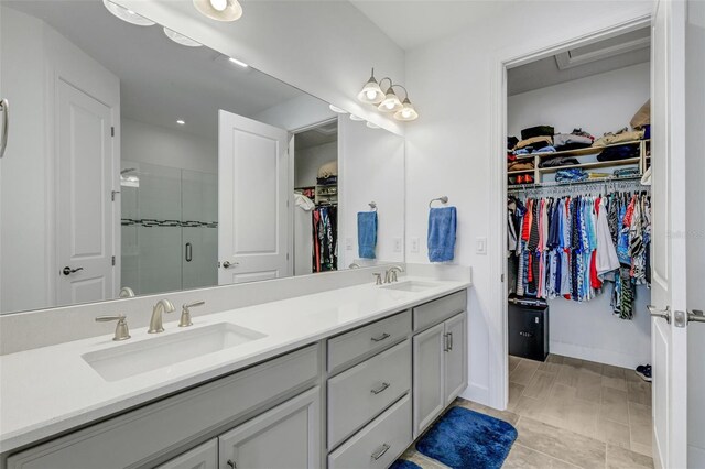 bathroom featuring vanity and an enclosed shower