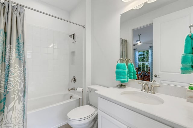 full bathroom featuring vanity, ceiling fan, toilet, and shower / bath combo with shower curtain