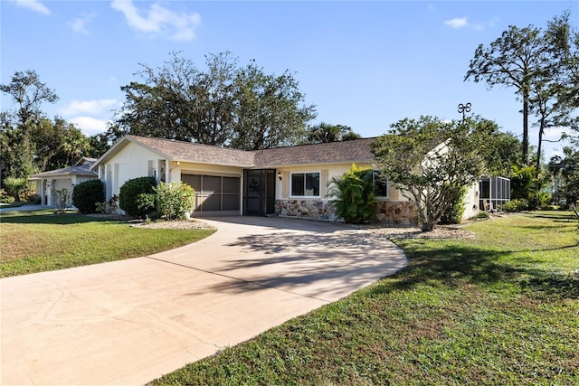 single story home featuring a front lawn and a garage