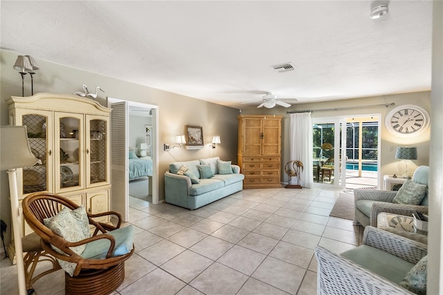 living room with ceiling fan and light tile patterned floors