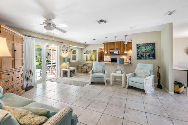 living room featuring light tile patterned floors and ceiling fan