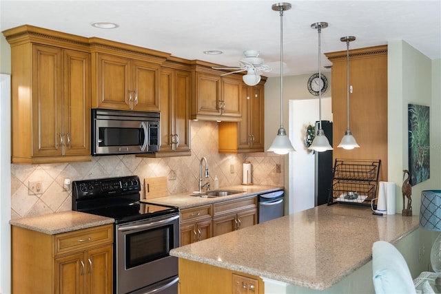 kitchen featuring pendant lighting, sink, decorative backsplash, kitchen peninsula, and stainless steel appliances