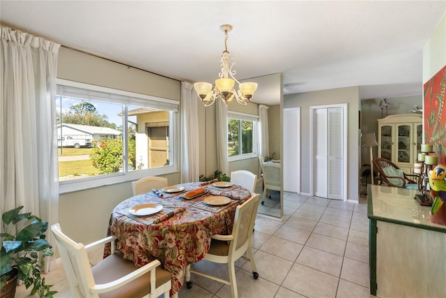 dining area featuring light tile patterned floors and a notable chandelier