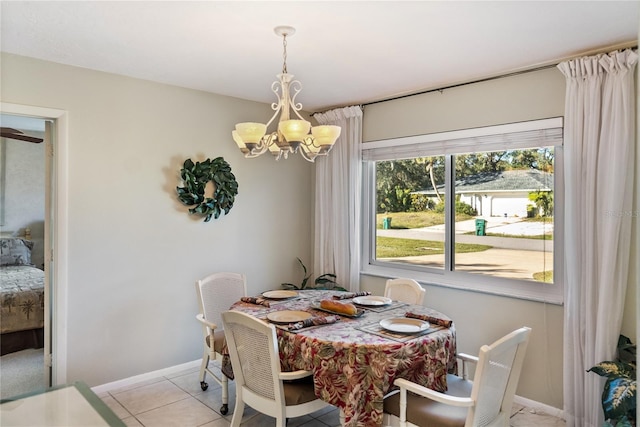 dining area featuring light tile patterned flooring and a notable chandelier