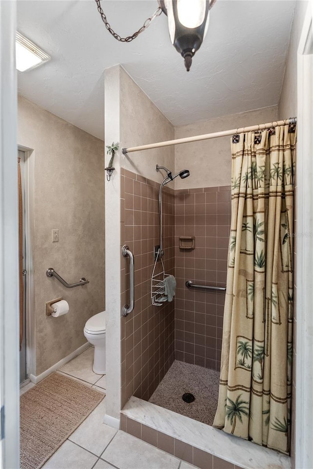 bathroom with tile patterned floors, toilet, and a shower with shower curtain