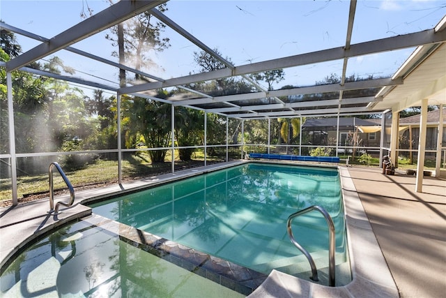 view of pool featuring glass enclosure and a patio area