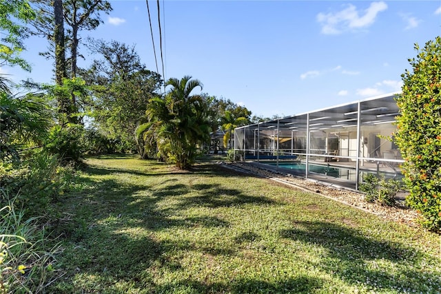 view of yard featuring glass enclosure