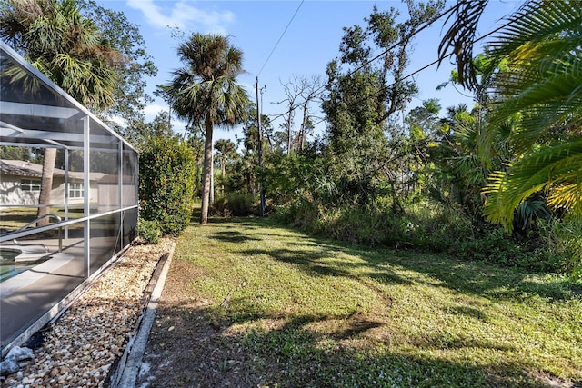 view of yard with glass enclosure