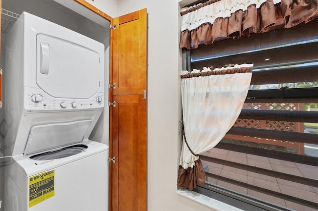 clothes washing area with stacked washer / drying machine