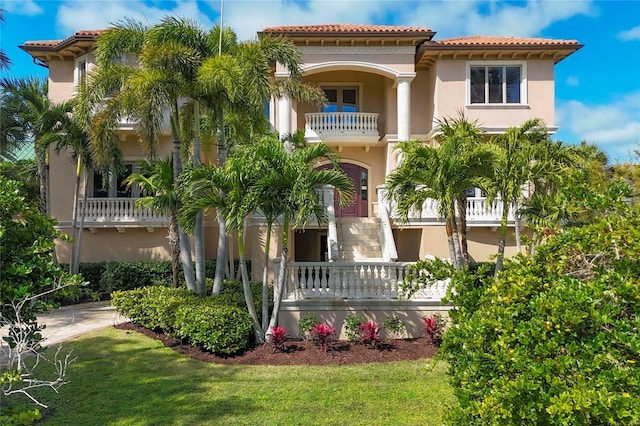 mediterranean / spanish house featuring a balcony