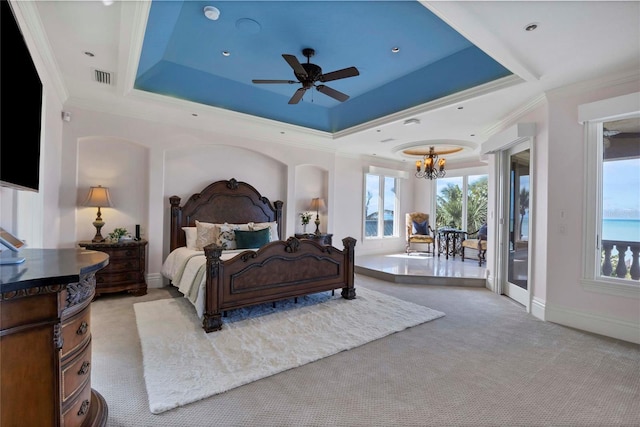 bedroom with a tray ceiling, crown molding, and light colored carpet