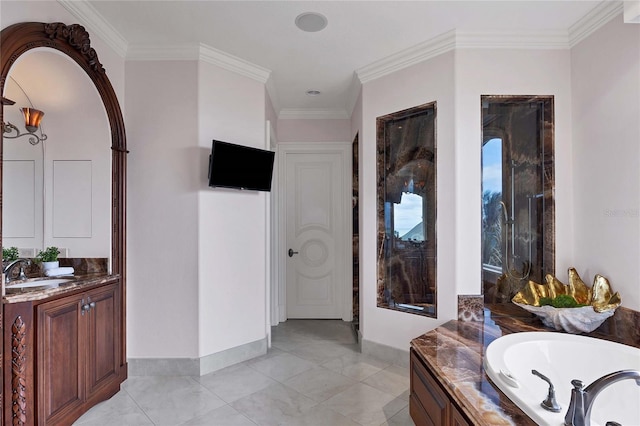 bathroom featuring vanity, crown molding, and a washtub