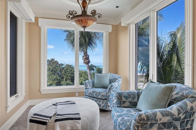 sitting room featuring ornamental molding and a healthy amount of sunlight