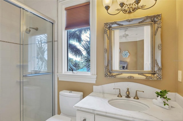 bathroom featuring vanity, toilet, and an enclosed shower