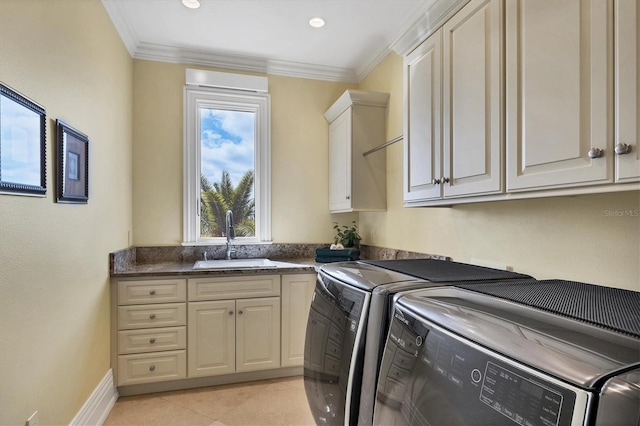 clothes washing area featuring cabinets, separate washer and dryer, and ornamental molding