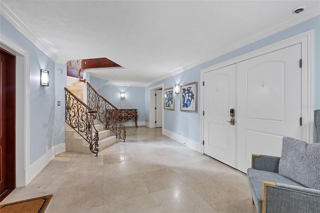 entryway featuring ornamental molding and a textured ceiling